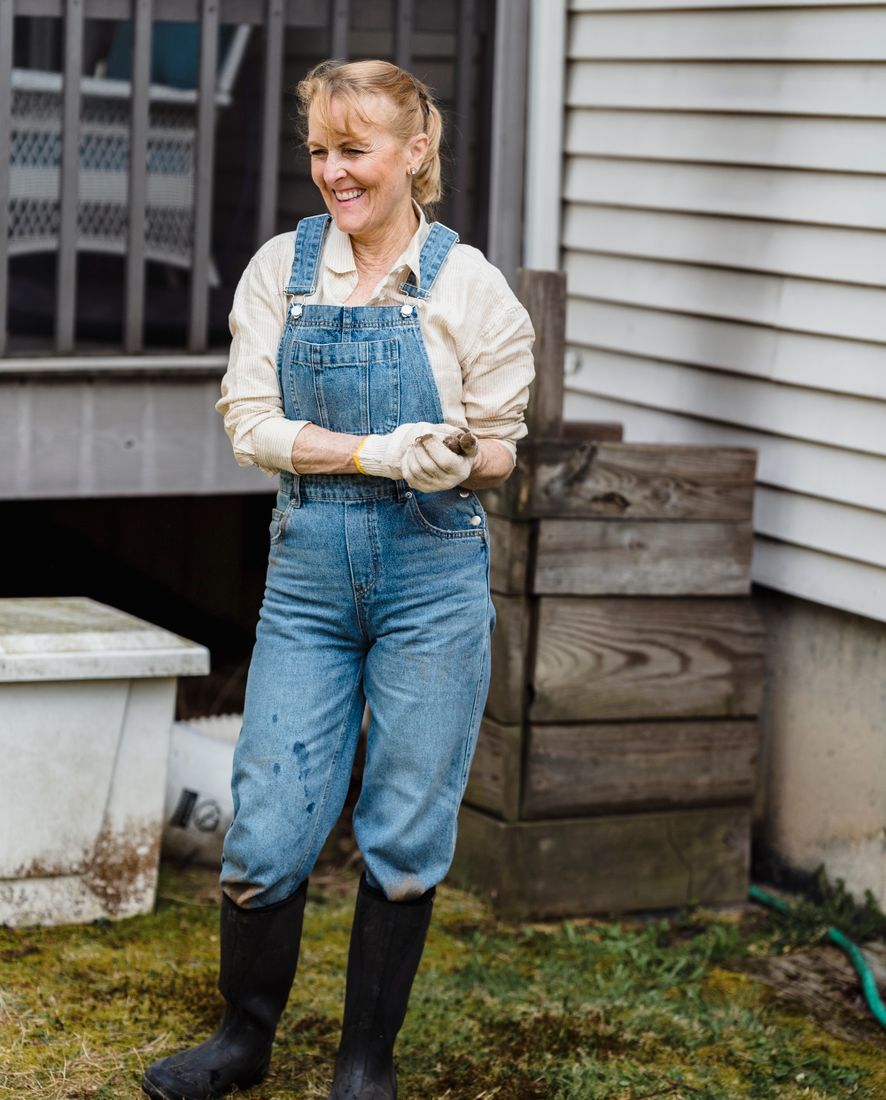 An older woman gardening, smiling