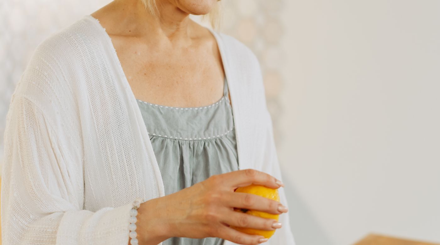 An older woman at a kitchen counter with her morning drink