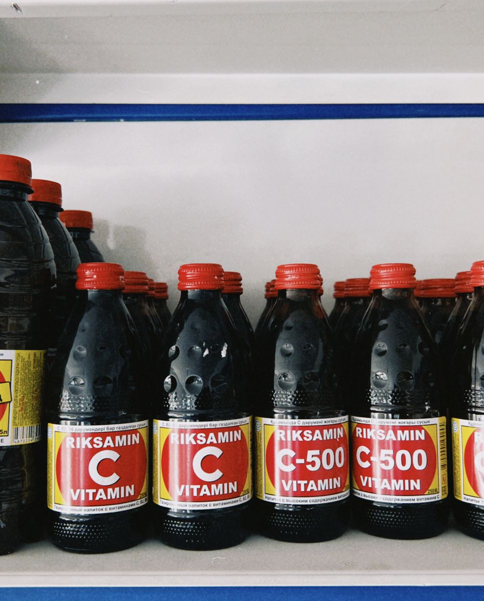 A crowded shelf of mismatched supplement bottles